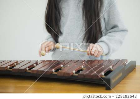 Child practicing xylophone Child practicing xylophone 129192648