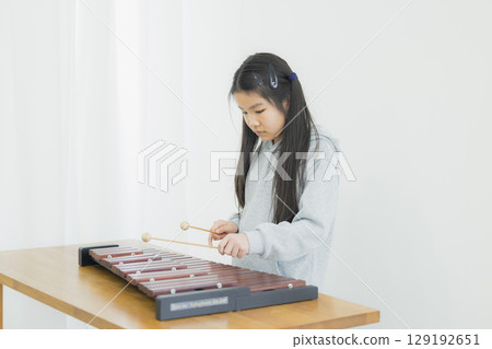 Child practicing xylophone Child practicing xylophone 129192651