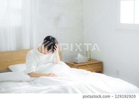 A young man sitting in bed A young man sitting in bed 129192920