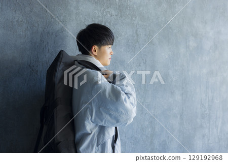 Young man using smartphone in bed 129192968