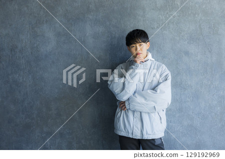 Young man using smartphone in bed 129192969