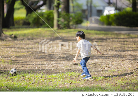 Children and men in polo shirts playing in the park 129193205