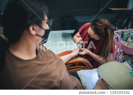 Nail technician manicure or pedicure at nail salon Nail technician manicure or pedicure at nail salon 129193282