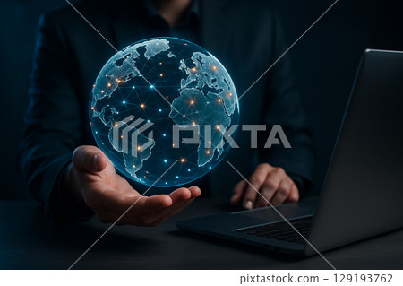 AI generated ultra realistic concept of businessman holding glowing digital holographic globe with network connections above laptop symbolizing global technology and intelligent data systems AI generated ultra realistic concept of businessman holding glowing digital holographic globe with network connections above laptop symbolizing global technology and intelligent data systems 129193762