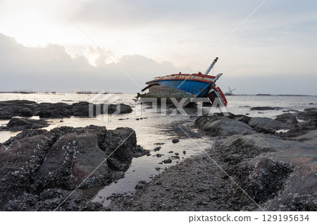 Old wrecked fishing boat on coast of Ang Sila Village, Saensuk Sub-district, Chonburi Province of thailand. Old wrecked fishing boat on coast of Ang Sila Village, Saensuk Sub-district, Chonburi Province of thailand. 129195634