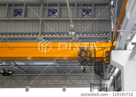 Overhead crane or lifting equipment inside factory or warehouse. 129195718