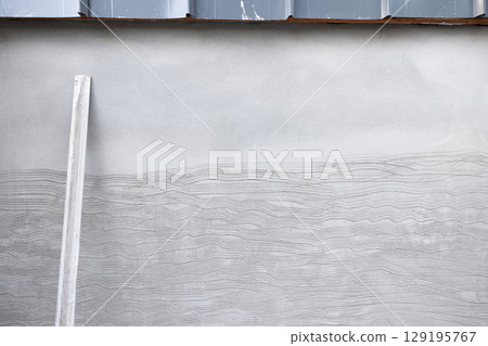 Concrete plastering wall and scrate surface to prepare for tile installation. Concrete plastering wall and scrate surface to prepare for tile installation. 129195767