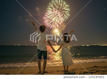 Couple enjoying the fireworks display on the beach 129195901