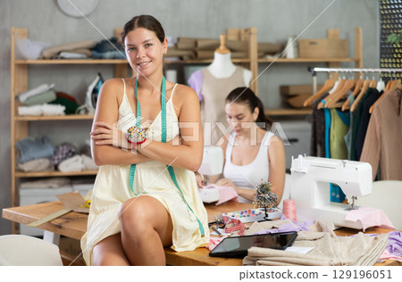 Young woman tailor designer is in sewing office 129196051