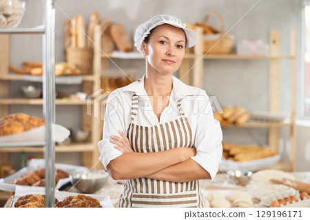 Confident female baker with folded hands Confident female baker with folded hands 129196171