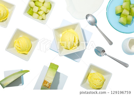 Yellow melon sorbet in bowls with fruit, isolated on white, PNG 129196759