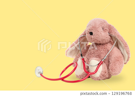 Bunny with stethoscope on a bright yellow background 129196768