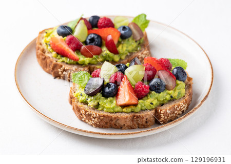 Avocado toast with strawberry, blueberry, raspberry and grape. Healthy eating Avocado toast with strawberry, blueberry, raspberry and grape. Healthy eating 129196931