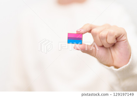 Bisexuality Celebrate Day and LGBT pride month, LGBTQ or LGBTQIA concept. Hand holding purple, pink and blue flag shape for Lesbian, Gay, Bisexual, Transgender, Queer, Pansexual, Marriage Equality Law 129197149