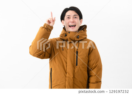 Young man wearing a down coat Young man wearing a down coat 129197232