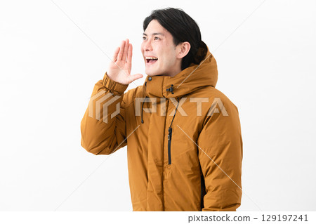 Young man wearing a down coat Young man wearing a down coat 129197241