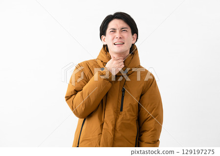 Young man wearing a down coat Young man wearing a down coat 129197275