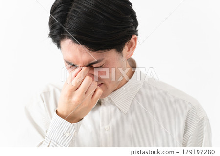 Young man wearing a long-sleeved white shirt Young man wearing a long-sleeved white shirt 129197280