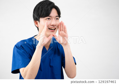 A young man wearing medical scrubs A young man wearing medical scrubs 129197461