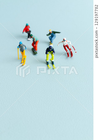 Miniature figurines of skiers and snowboarders posed in a dynamic winter sports lineup Miniature figurines of skiers and snowboarders posed in a dynamic winter sports lineup 129197782