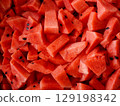 Close-up of fresh watermelon slices with vibrant red color and visible seeds. 129198342