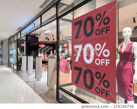 Massive clearance sale in Penang shopping complex with mannequins showcasing offers Massive clearance sale in Penang shopping complex with mannequins showcasing offers 129198736