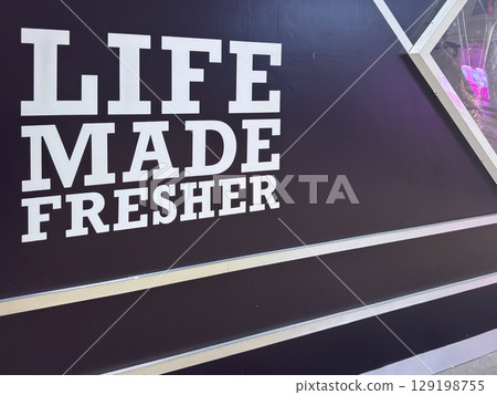 Life made fresher sign on black background showcasing brand message 129198755