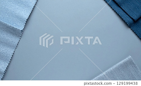 A calm background with fabric swatches layered on the corners 129199438