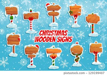 Cartoon Christmas wooden signs stickers, north pole signages. Vector holiday winter festive pointers with snow, holly, candy canes, ribbons, and decorations at snowy background with falling snowflakes 129199487