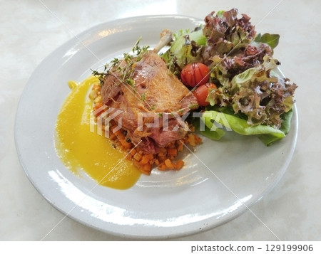 Gourmet Duck Confit with Caramelized Peaches, French Cuisine Fine Dining Dish Gourmet Duck Confit with Caramelized Peaches, French Cuisine Fine Dining Dish 129199906