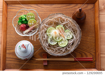Sudachi-scented chilled soba noodles - a refreshing Japanese lunch perfect for summer. Image for advertising. Sudachi-scented chilled soba noodles - a refreshing Japanese lunch perfect for summer. Image for advertising. 129200695