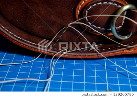 The process of leather processing, making a seam 129200790