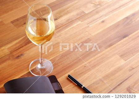 Imagine yourself sipping white wine and writing in a brown leather organizer. Imagine yourself sipping white wine and writing in a brown leather organizer. 129201029