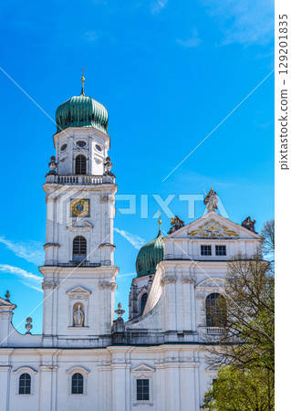 St. Stephans cathedral in Passau, Germany is an old white church with green metal domes on top of the towers St. Stephans cathedral in Passau, Germany is an old white church with green metal domes on top of the towers 129201835