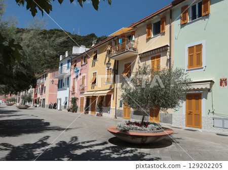 Old street in Italian countryside near sea. Traditional building. Sun day. Entrance, window to house. Nature and sky. 129202205