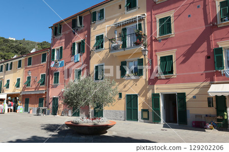 Old street in Italian countryside near sea. Traditional building. Sun day. Entrance, window to house. Nature and sky. 129202206