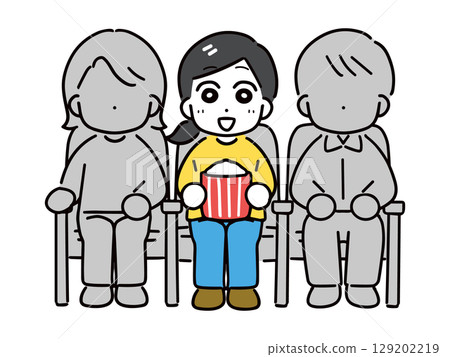 Smiling woman watching a movie alone at the cinema 129202219