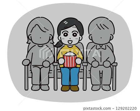 Smiling woman watching a movie alone at the cinema 129202220