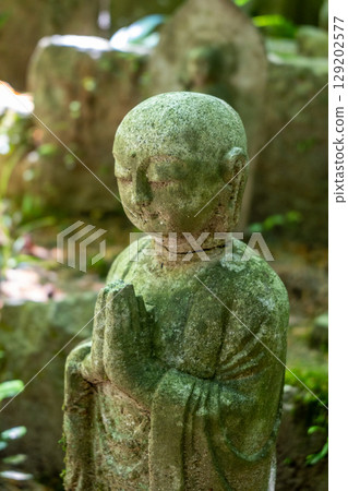 Monk statue in serene Mitaki-Dera temple garden in Hiroshima 129202577