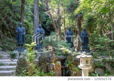 Bronze monk statues at Mitaki-Dera temple in Hiroshima, Japan 129202578