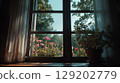 Warm sunlight illuminates a window with pink roses, green trees, and a houseplant. 129202779