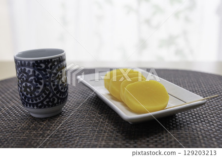 Pickled radish and Japanese tea on the table 129203213