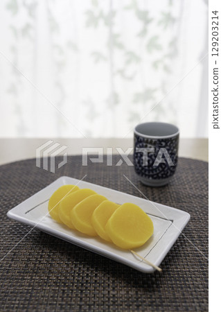 Pickled radish and Japanese tea on the table 129203214