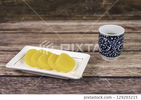 Pickled radish and Japanese tea on the table 129203215