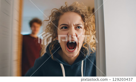 Teenager yelling at parents, slamming door in his room, conflict between children and parents 129203437