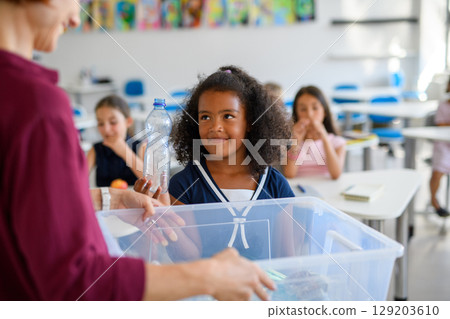 Young children learning about sustainability and ecology, sorting waste. Young children learning about sustainability and ecology, sorting waste. 129203610