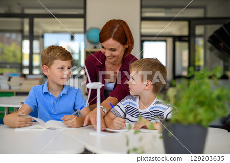 Young children learning about sustainability with teacher in classroom 129203635