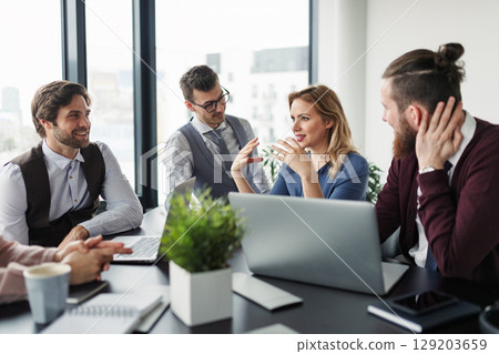 Business colleagues sharing ideas, discussing new project. 129203659