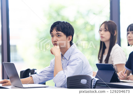 University students attending a lecture University students attending a lecture 129204673