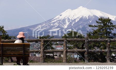 woman have a look to Mount Iwaki,  it is the highest mountain in Aomori Prefecture, Japan 129205239
